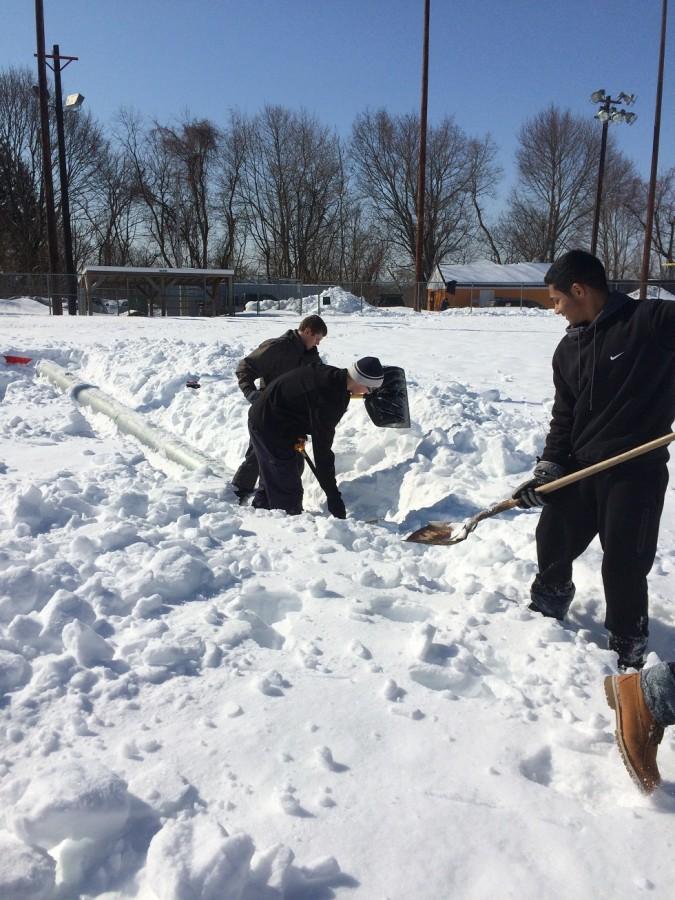 Players had to dig around light poles that were buried under the snow.