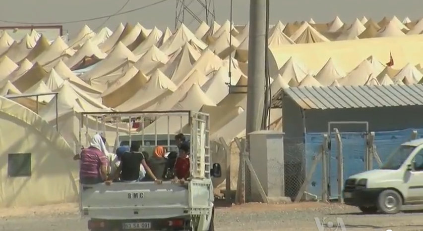 Syrian refugees enter a camp just over the Turkish border.