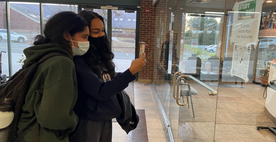 Seniors Shreya Suresh and Sonal Gupta check out to leave campus during a study hall.